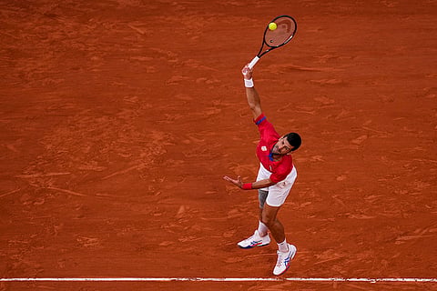 Novak Djokovic serves against Lorenzo Musetti 